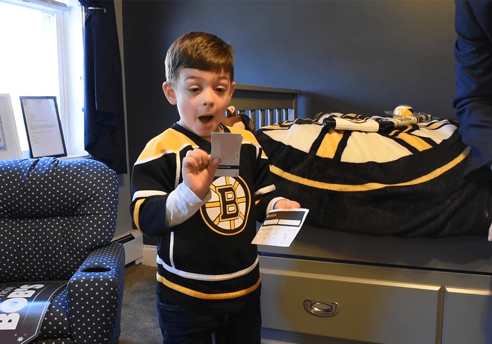 Grant reacts to receiving tickets to a Boston Bruins game.
