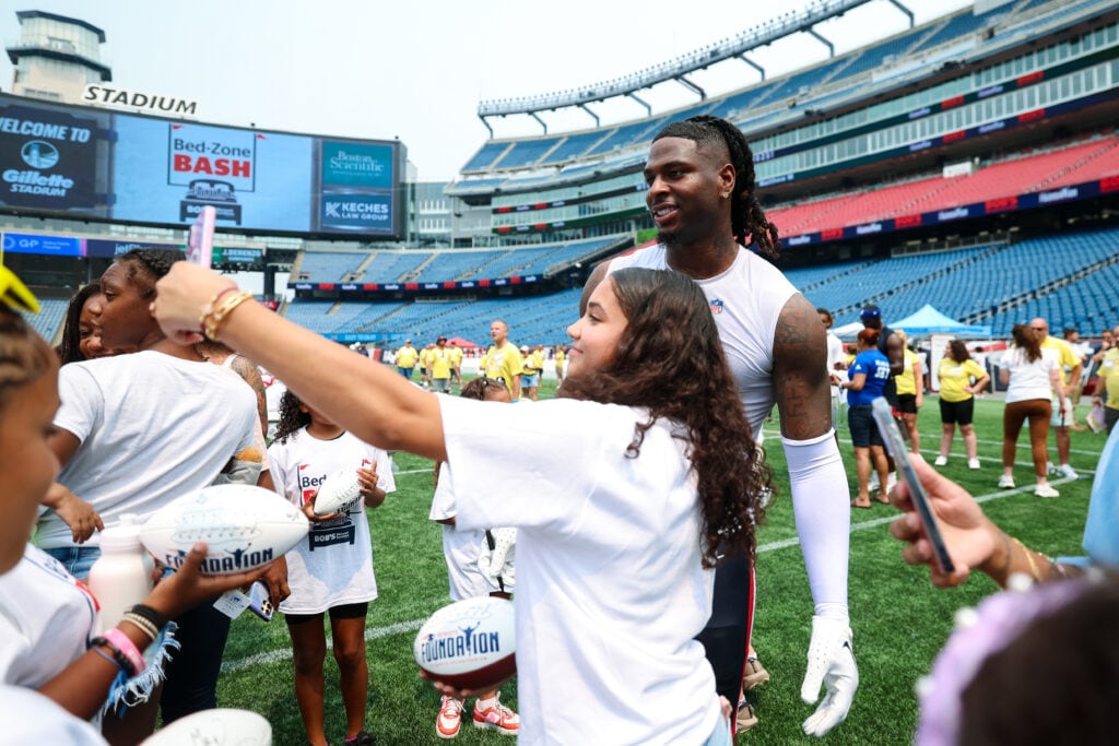 Jahiem Bell, Tight End, poses with attendees of the Bed-Zone Bash. Courtesy of the New England Patriots.