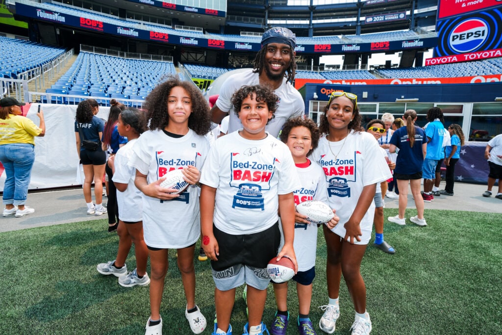 Miles Battle, Cornerback, poses with attendees of the Bed-Zone Bash. Courtesy of the New England Patriots.