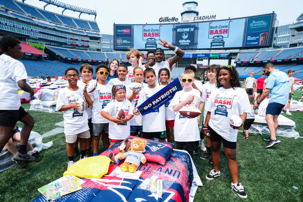 Stefon Diggs, Wide Receiver, poses with attendees of the Bed-Zone Bash. Courtesy of the New England Patriots.