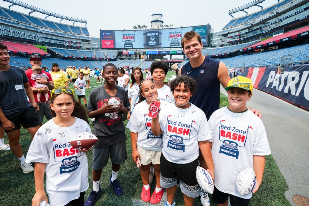 Drake Maye, Quarterback, poses with attendees of the Bed-Zone Bash. Courtesy of the New England Patriots.
